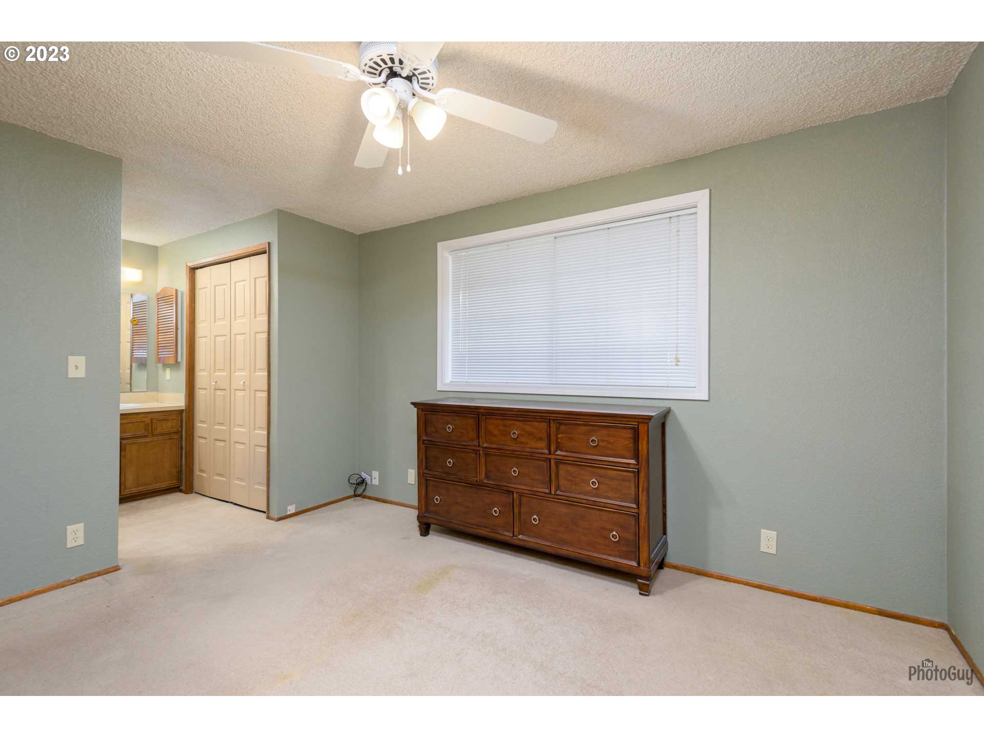 4888 B Street Springfield, OR 97478 - Photo 18 of 32 a room with furniture and a chandelier fan