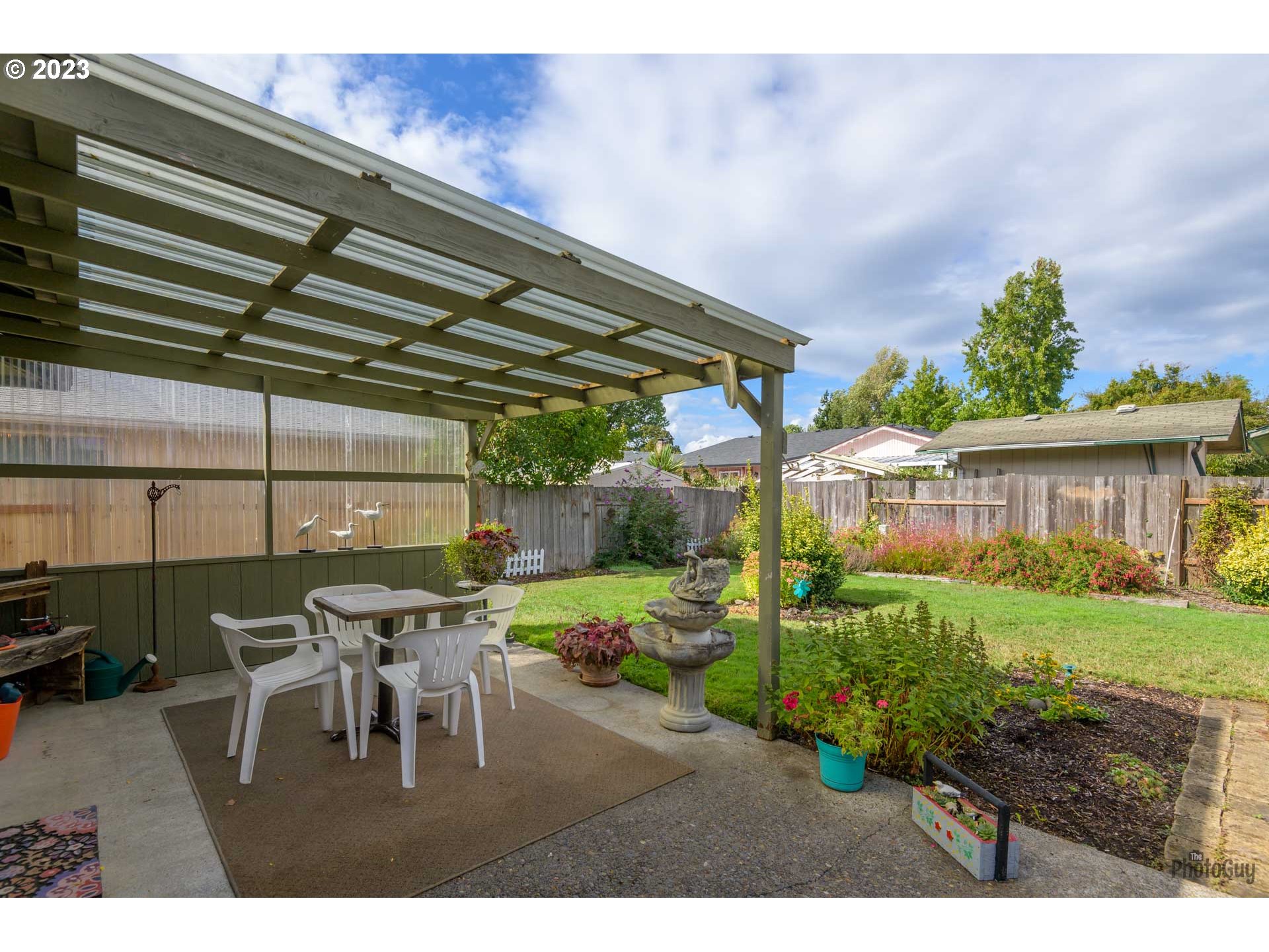 4888 B Street Springfield, OR 97478 - Photo 24 of 32 a view of a patio with table and chairs and potted plants
