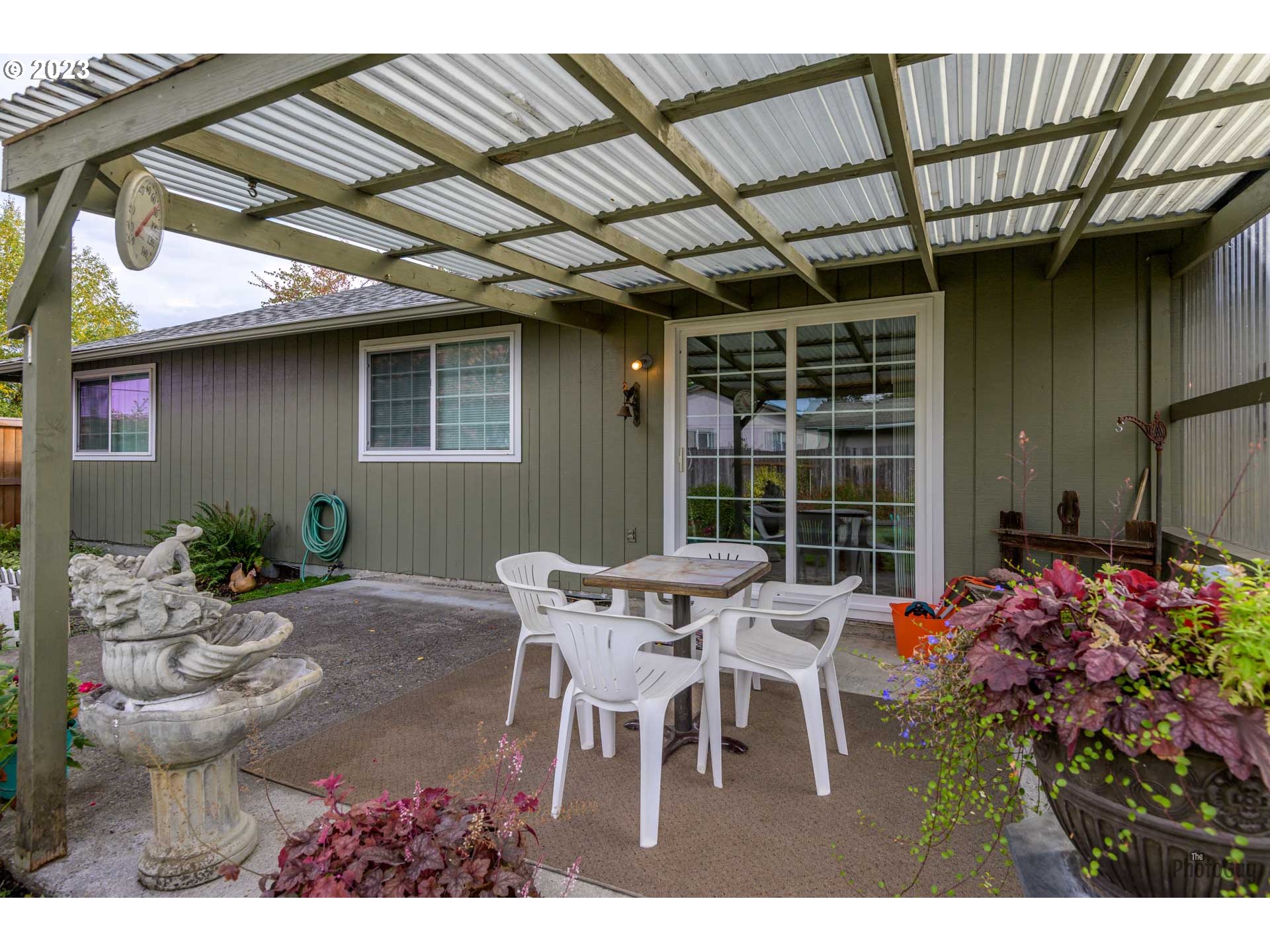 4888 B Street Springfield, OR 97478 - Photo 27 of 32 a patio with a table and chairs and potted plants