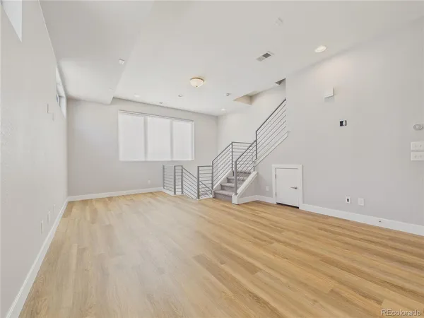 a view of empty room with stairs