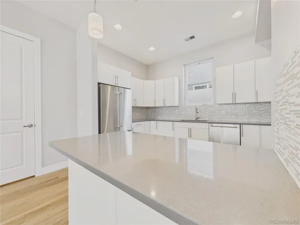 a large kitchen with kitchen island a sink stainless steel appliances and cabinets