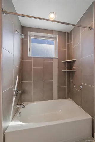 a bathroom with a bathtub and a shower