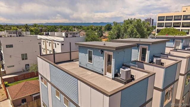 a view of a balcony with a floor to ceiling window and wooden fence