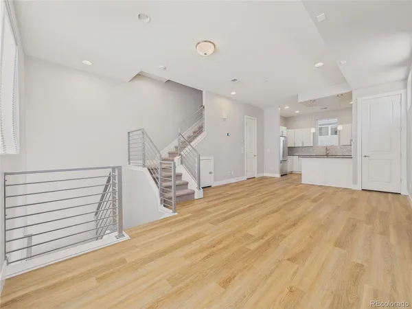 a view of empty room with wooden floor