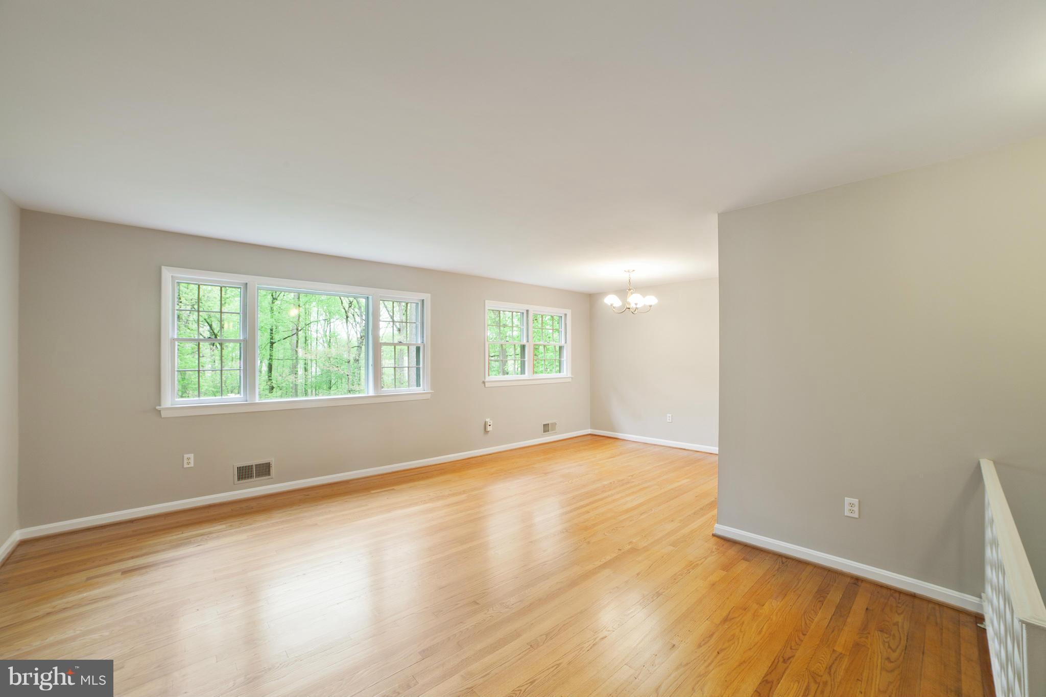 13133 Clifton Road Silver Spring, MD 20904 - Photo 4 of 29 an empty room with wooden floor and windows
