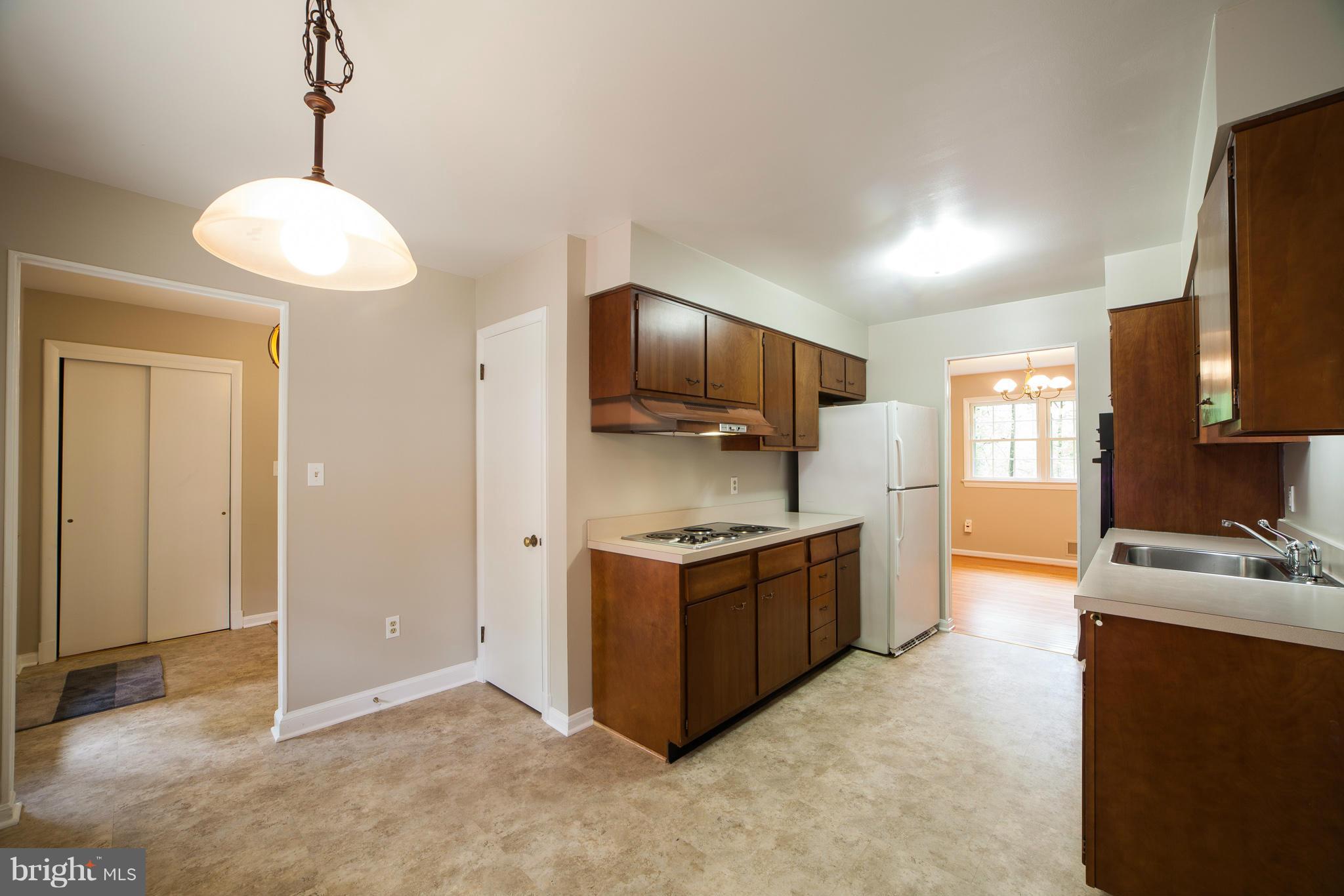 13133 Clifton Road Silver Spring, MD 20904 - Photo 7 of 29 a kitchen with stainless steel appliances granite countertop a stove and a refrigerator