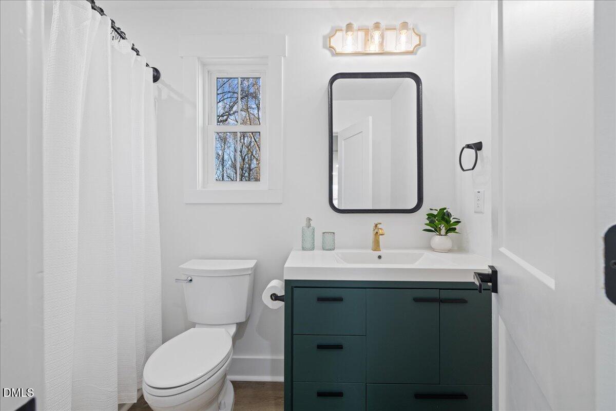 617 North 3rd Street Mebane, NC 27302 - Photo 36 of 50 a bathroom with a toilet sink and mirror