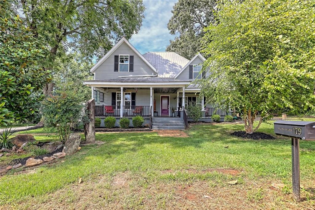a front view of a house with swimming pool yard and patio