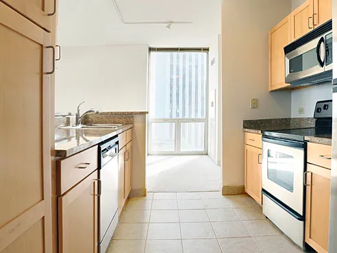 a kitchen with stainless steel appliances granite countertop a refrigerator and a stove top oven