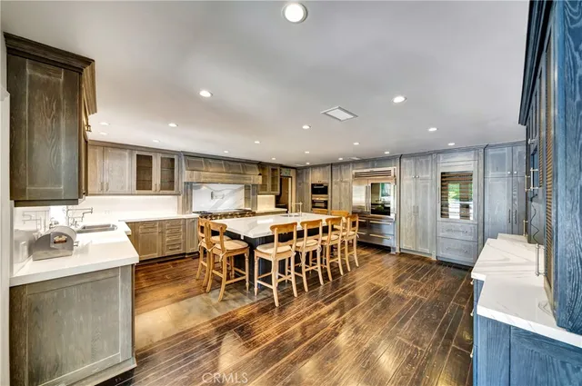 a large kitchen with a center island and stainless steel appliances
