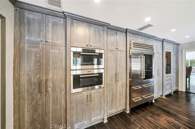 a dining table chair with granite countertop a stove and a refrigerator