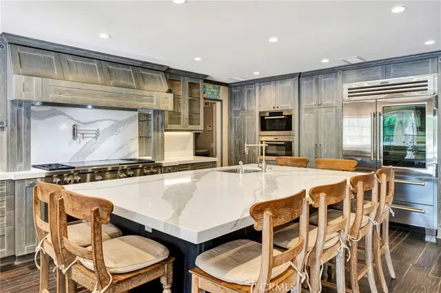a kitchen with a refrigerator and a sink