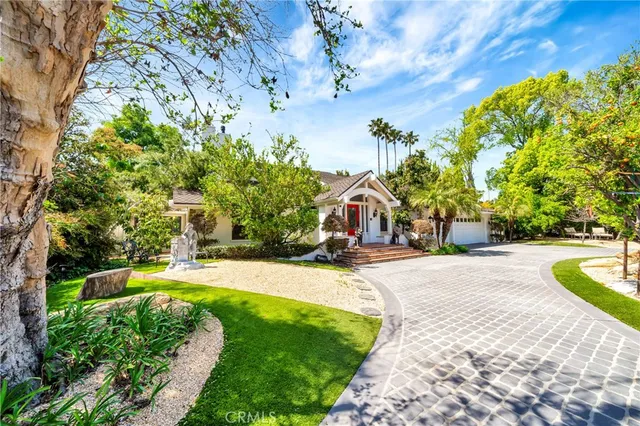 a view of a chair and table in the backyard of the house