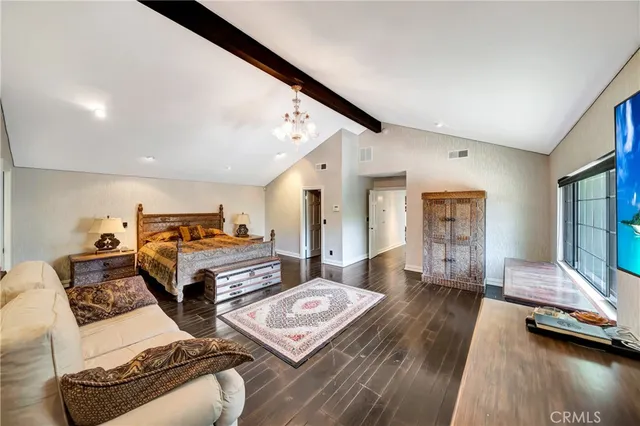 a large bathroom with a granite countertop double vanity sink a mirror and a bathtub