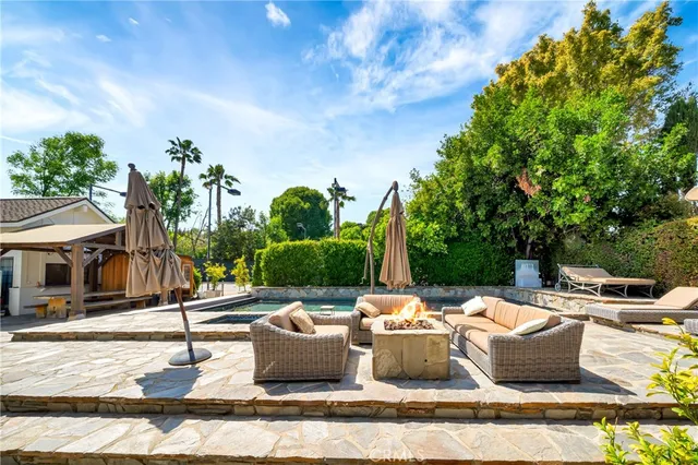 a living room with furniture floor to ceiling window and floor to ceiling window