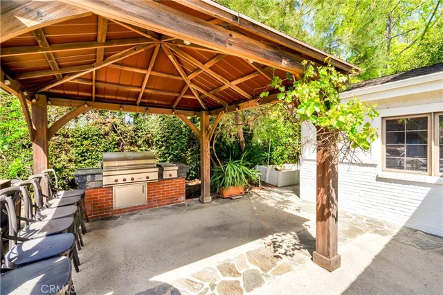 a view of a house with backyard and sitting area