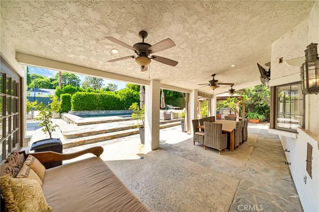 a view of a house with backyard and sitting area