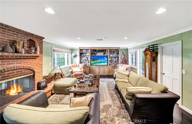a living room with furniture fireplace and window