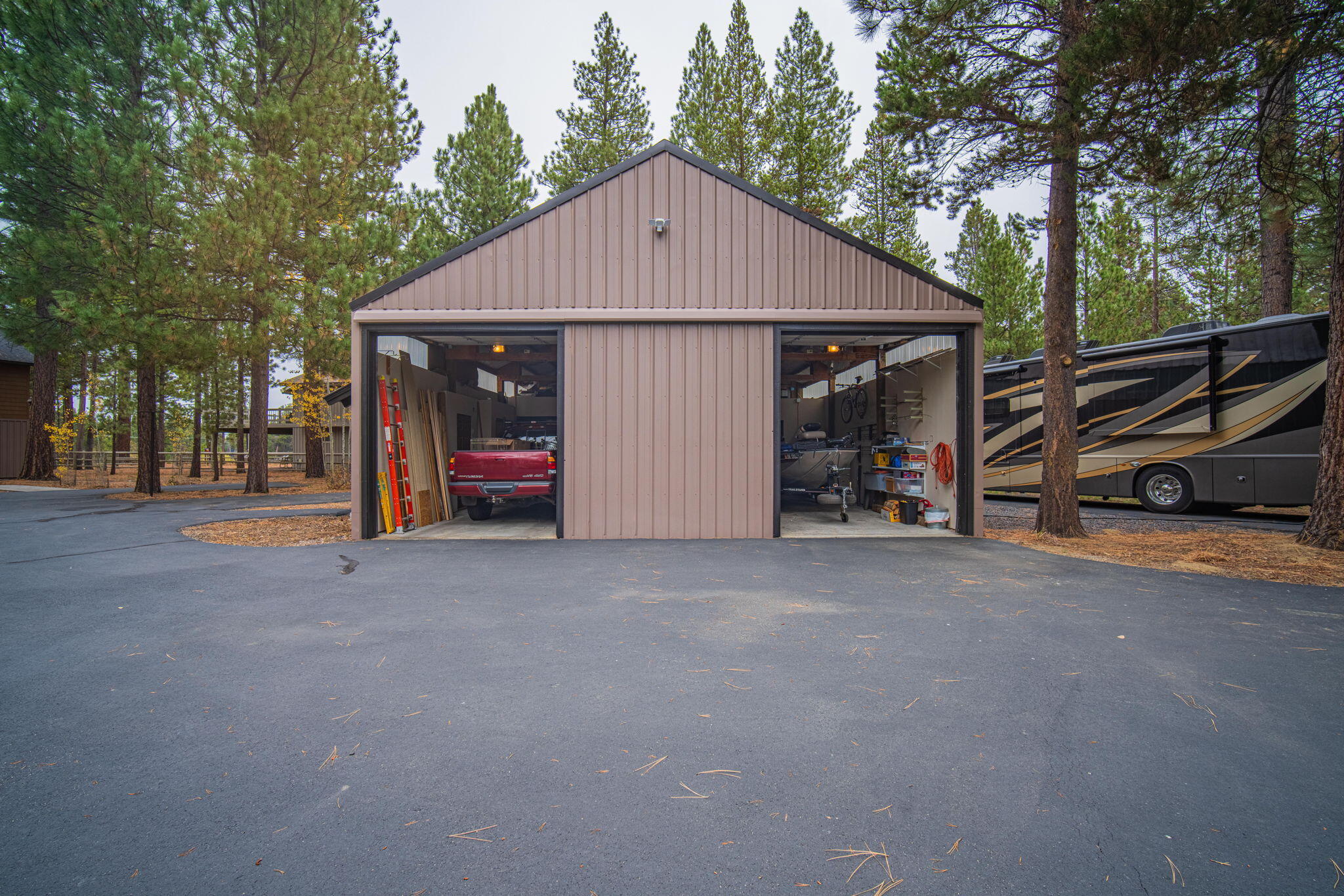 56019 Snow Goose Road Bend, OR 97707 - Photo 27 of 32 a view of a house with a yard and garage