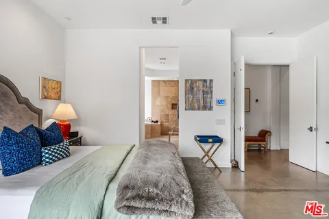a bedroom with a bed and a lamp on table