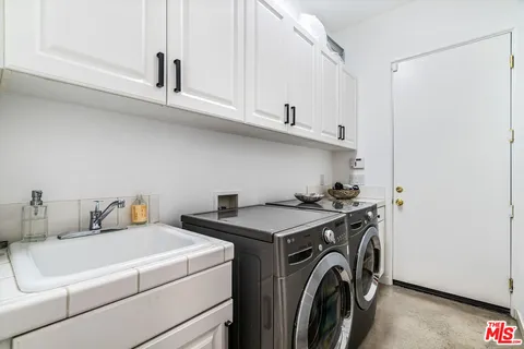a bathroom with a double vanity sink toilet and shower
