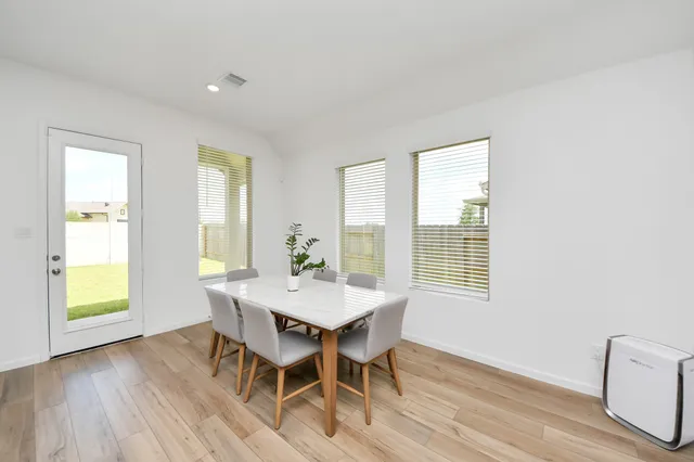a view of a dining room with furniture and wooden floor