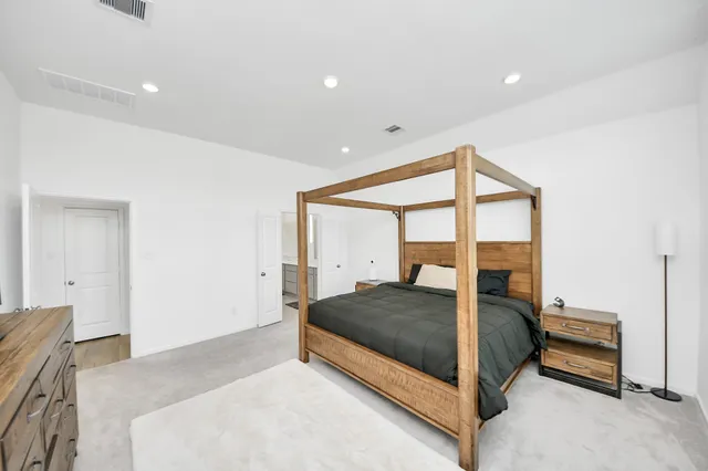 a bedroom with a bed and a large window