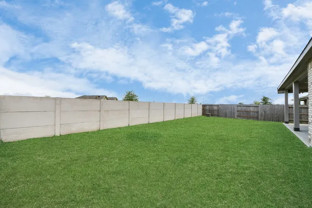 a view of a house with a yard and sitting area
