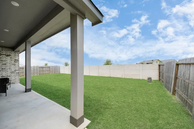 an aerial view of a house with a garden and swimming pool
