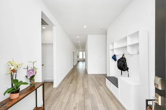 a view of a hallway view with wooden floor and staircase