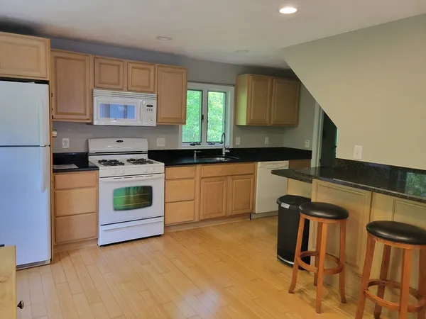 a kitchen with a sink appliances and cabinets