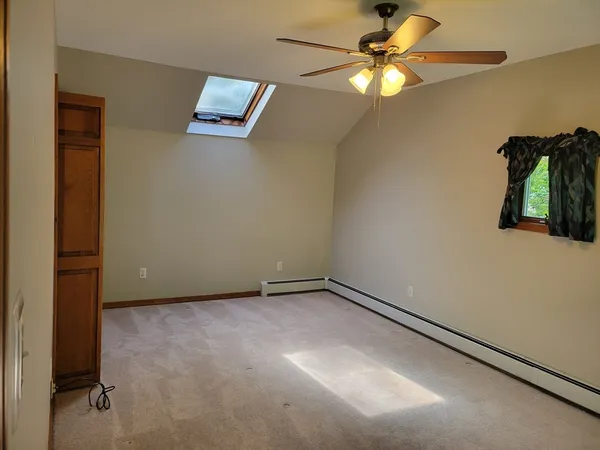 an empty room with closet and fan