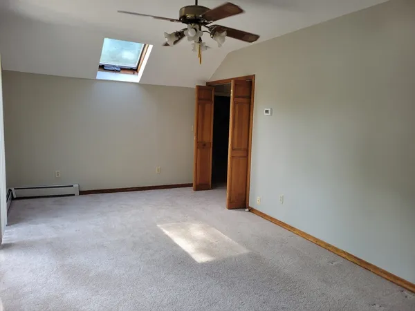 a view of a room with a ceiling fan
