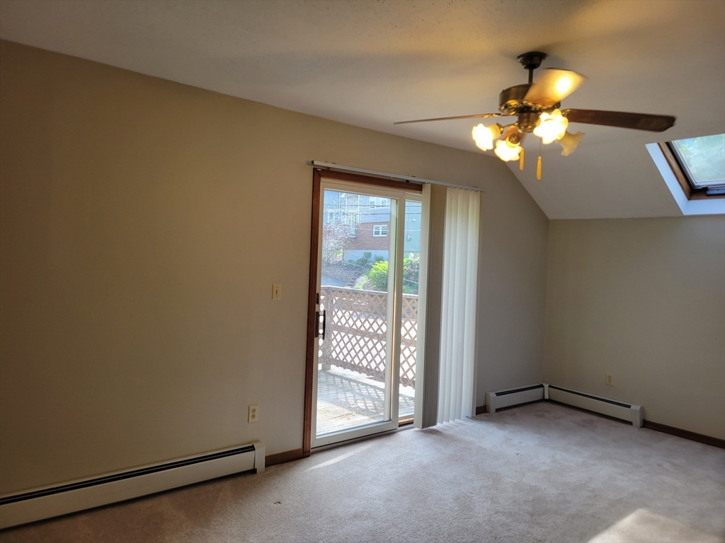 37 Golden Hills Road, Unit 37 Saugus, MA 01906 - Photo 19 of 22 a view of an empty room with window chandelier fan