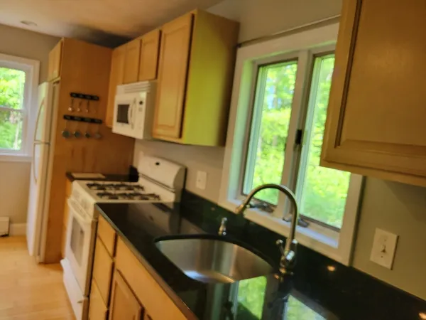 a kitchen with a sink a counter top space and a window