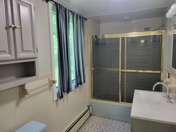 a bathroom with a shower and a sink