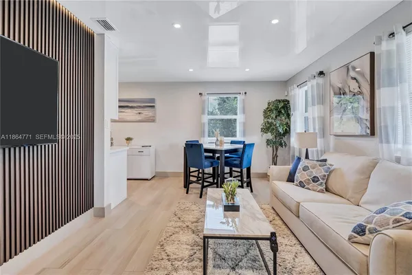 a living room with furniture a large window and a flat screen tv