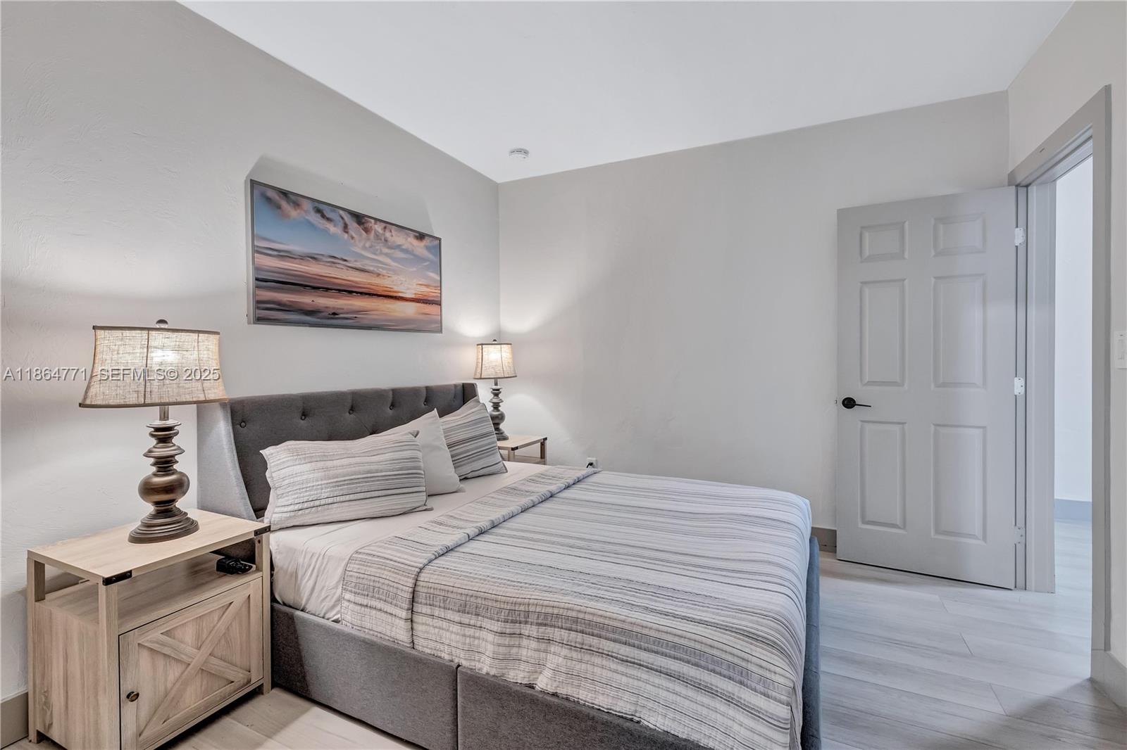 1390 Northeast 150th Street Miami, FL 33161 - Photo 12 of 32 a bedroom with a bed and a lamp