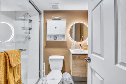 a bathroom with a toilet a sink and a mirror