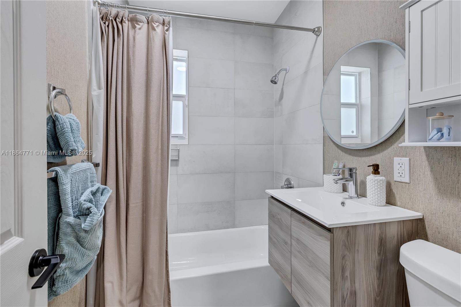 1390 Northeast 150th Street Miami, FL 33161 - Photo 16 of 31 a bathroom with a sink vanity toilet and shower