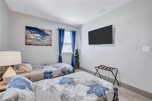 a bedroom with a bed and a flat screen tv