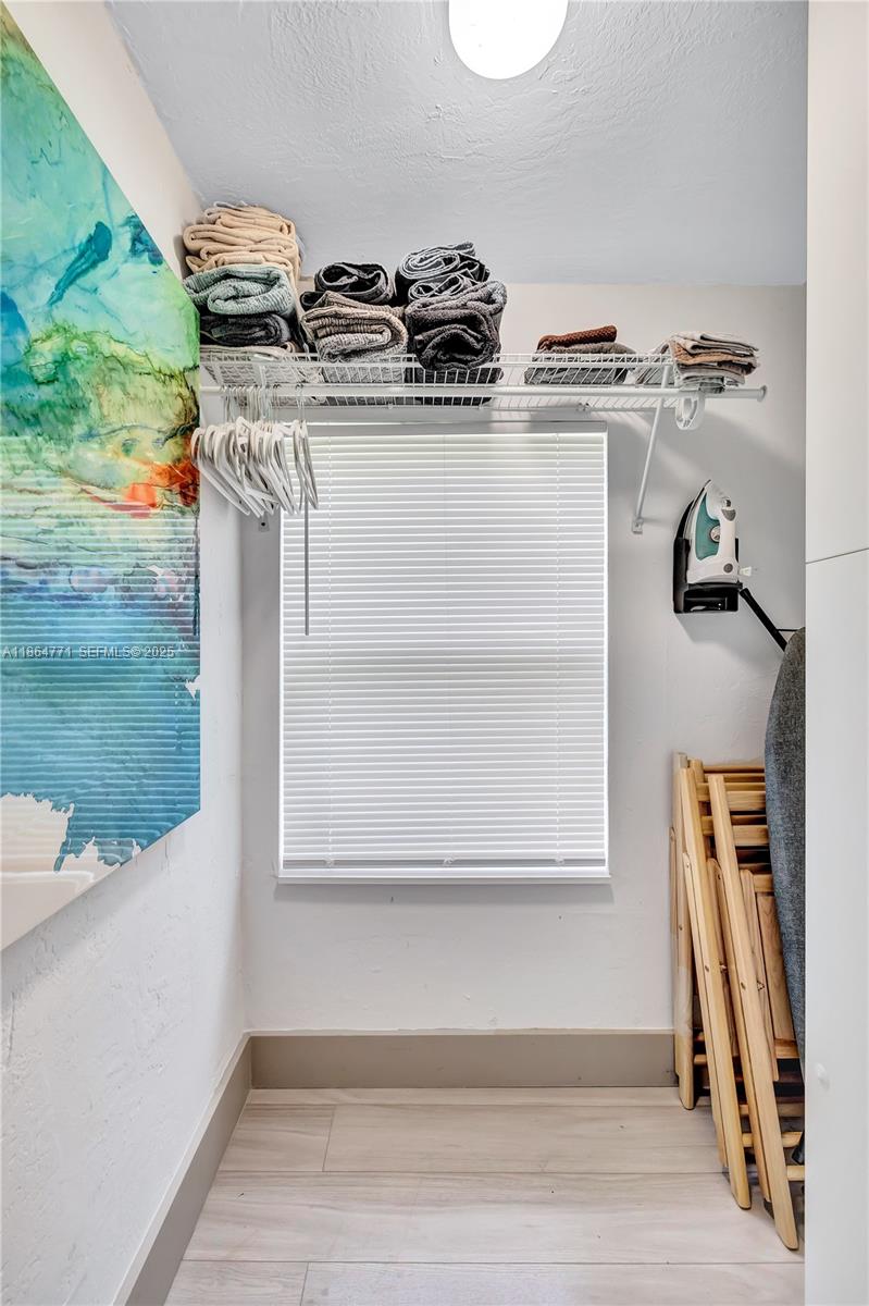 1390 Northeast 150th Street Miami, FL 33161 - Photo 22 of 32 a view of walk in closet with clothes and shoes