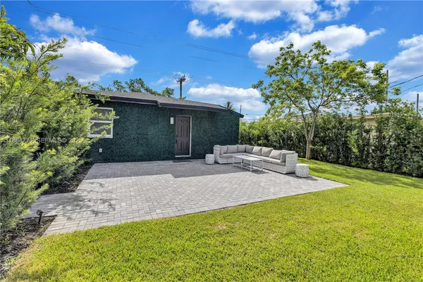 a view of a backyard with sitting area