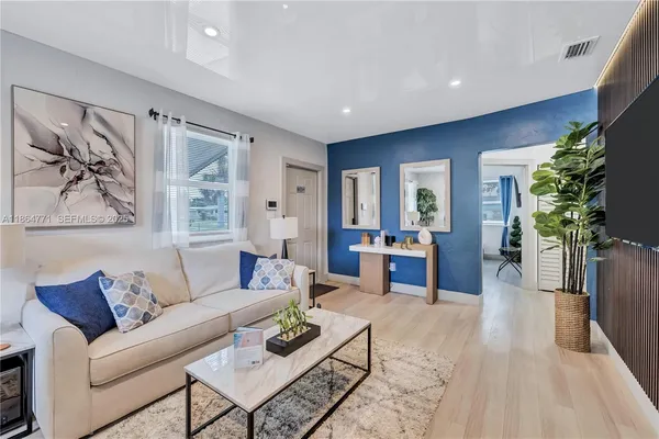 a living room with furniture and a potted plant