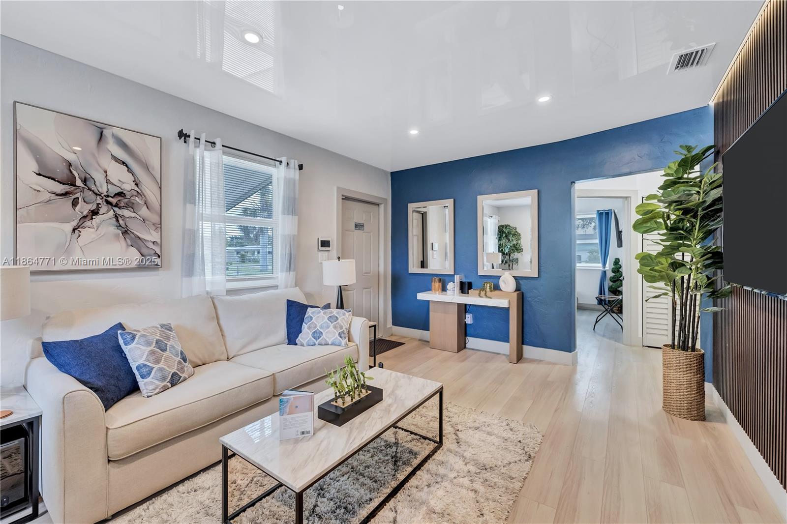 1390 Northeast 150th Street Miami, FL 33161 - Photo 3 of 31 a living room with furniture and a potted plant