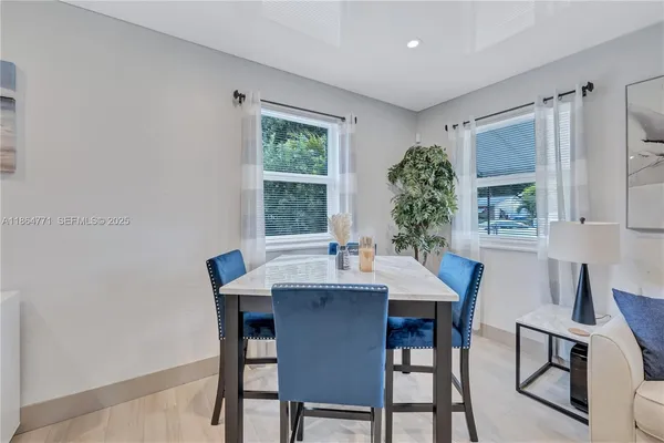 a view of a dining room with furniture and window