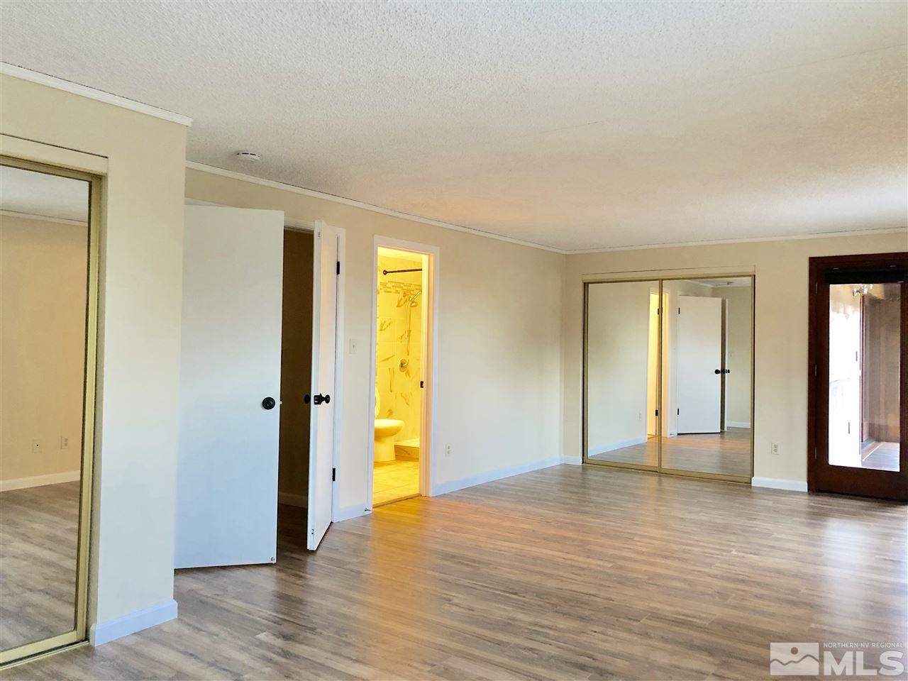 2755 Ravazza Road Reno, NV 89521 - Photo 8 of 25 a view of empty room with wooden floor and bathroom