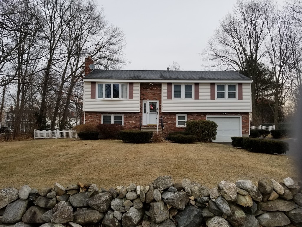 22 Wyman Road Billerica, MA 01821 - Photo 1 of 29 a front view of a house with yard covered in snow