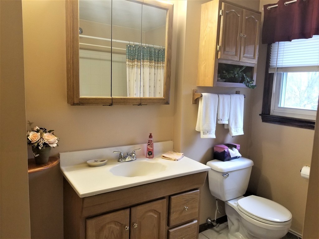 22 Wyman Road Billerica, MA 01821 - Photo 13 of 29 a bathroom with a sink a toilet and a window