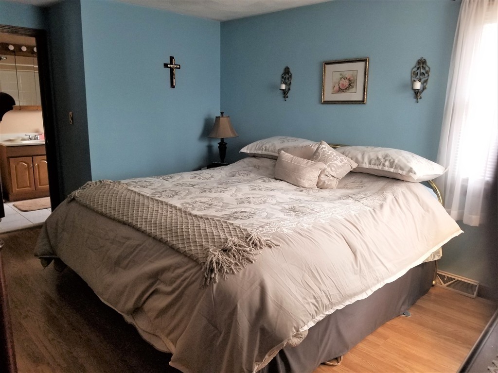 22 Wyman Road Billerica, MA 01821 - Photo 9 of 29 a bedroom with a bed and a window